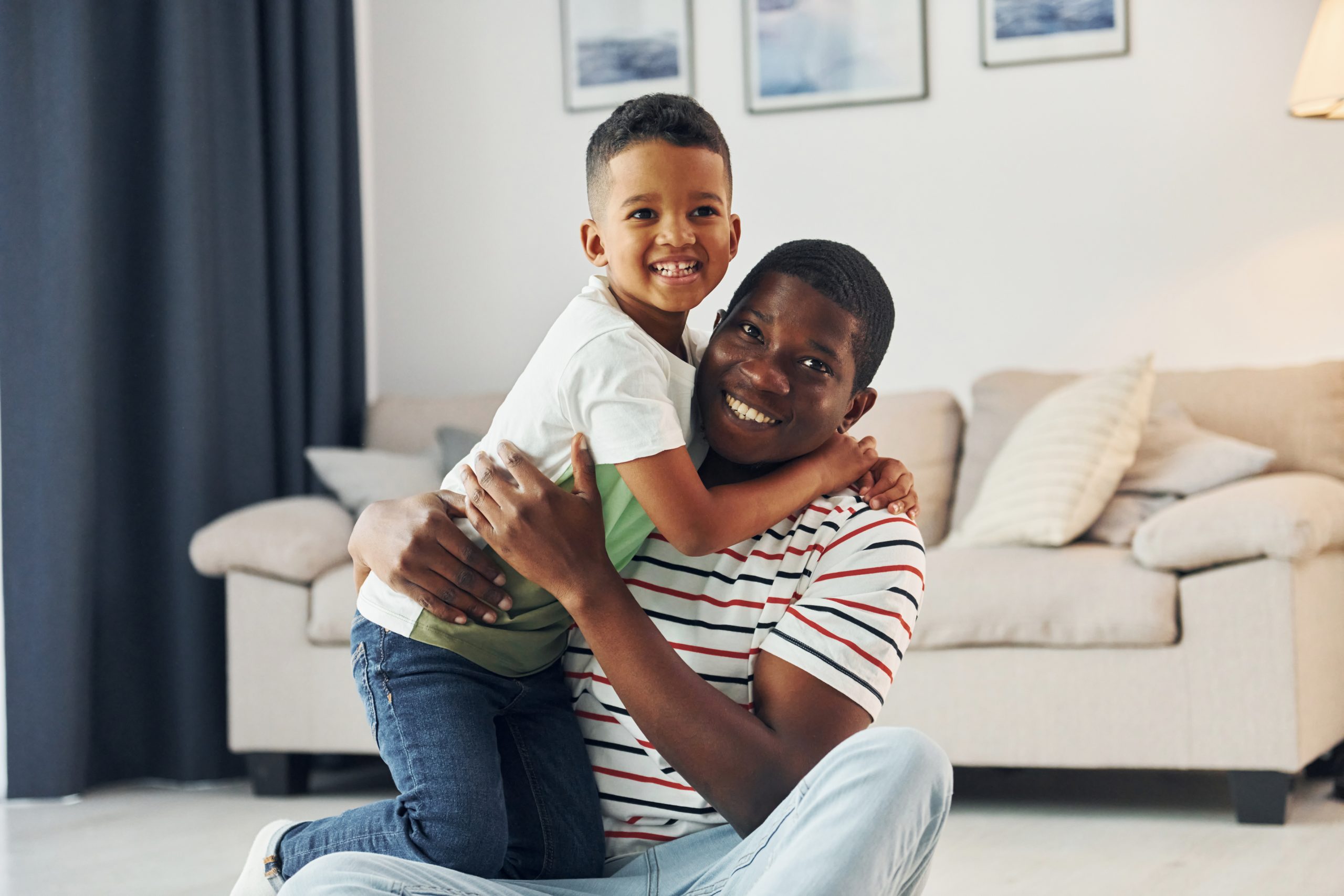 Happy family. African american father with his young son at home